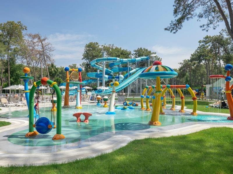 Colorful water park with slides and water features outdoors on a sunny day.