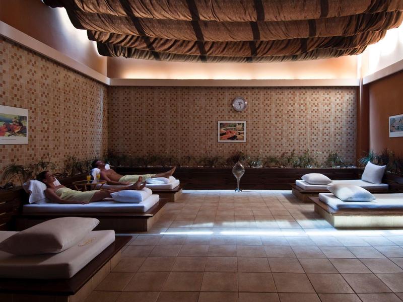 Cozy relaxation room with padded loungers and warm lighting in a hotel