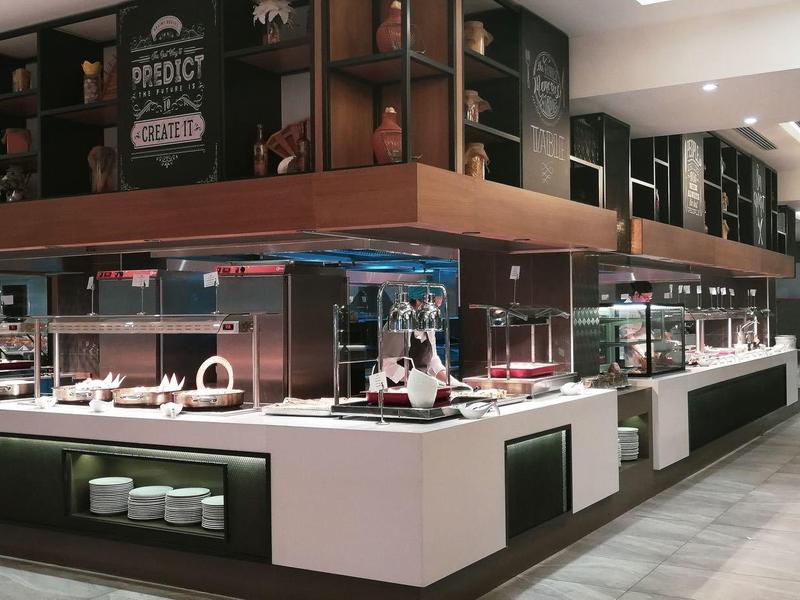 Modern hotel lobby with large buffet area and elegant interior design.