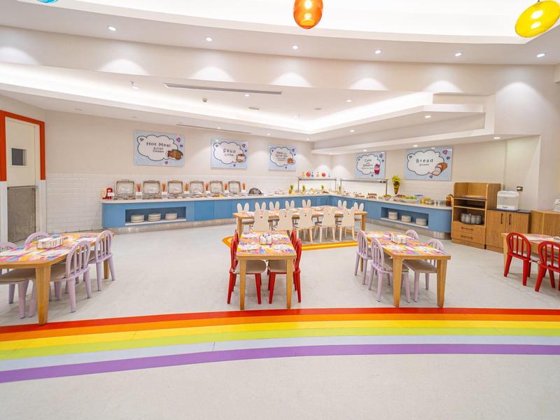 Bright and colorful dining room with tables and colorful chairs in a hotel