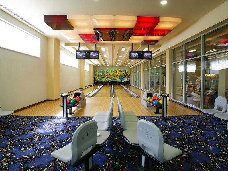 Interior of a hotel bowling alley with modern pins and seating