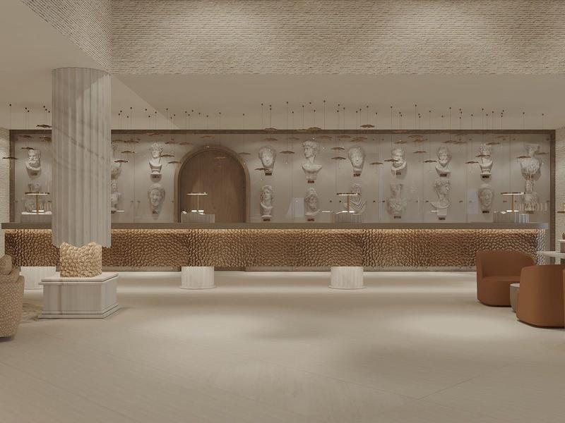 Vestíbulo de hotel elegante con asientos beige y marrones y recepción al fondo.