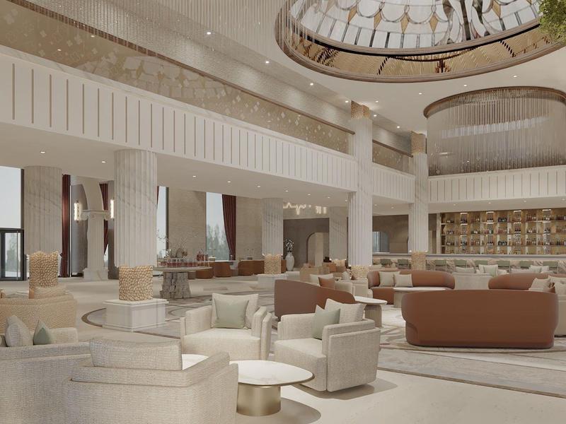 Amplia y luminosa recepción de hotel con sillones cómodos, sofás y ventana circular en el techo.