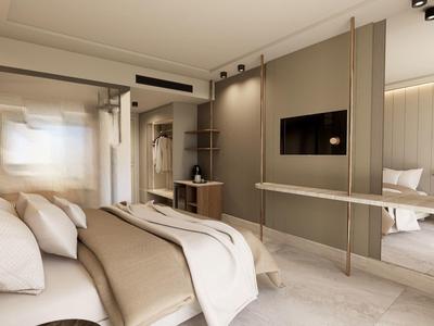 Habitación de hotel moderna con cama doble, televisor de pantalla plana y decoración beige-blanca.