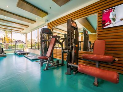 Een lichte fitnessruimte met moderne trainingsapparatuur en grote ramen.