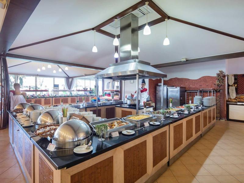 Spacious buffet area with stainless steel food warmers and abundant natural light.
