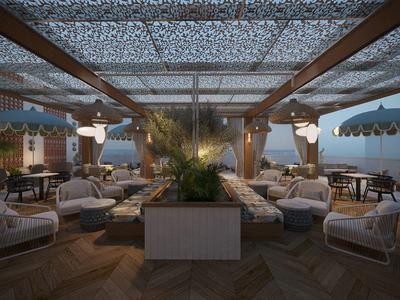 Zadaszony taras hotelowy z przytulnymi miejscami do siedzenia i ciepłym oświetleniem wieczorem.