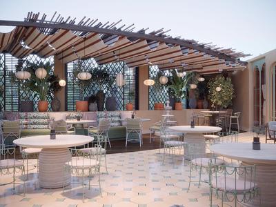 Area lounge all'aperto con tavoli rotondi e tettoia a pergola in un hotel.