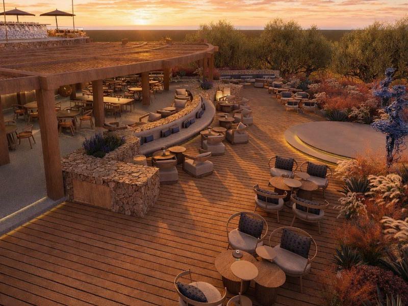 Terrasse extérieure confortable avec sièges et sol en bois au coucher du soleil.