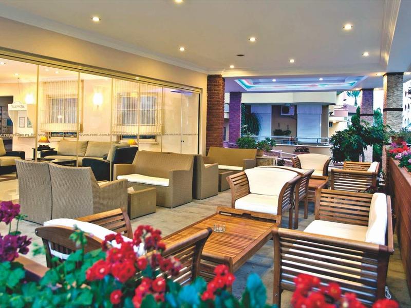 Espace extérieur confortable avec sièges et fleurs sur une terrasse d'hôtel.