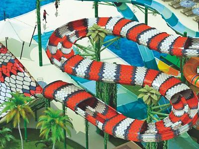 Colorful winding water slides in a tropical water park with palm trees.