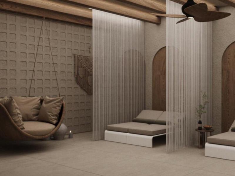 Chambre d'hôtel moderne avec fauteuils suspendus, deux lits et une cloison transparente.