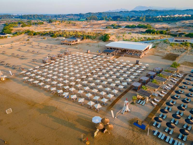 Vista aerea di un grande campo tende organizzato in un paesaggio arido e vasto.