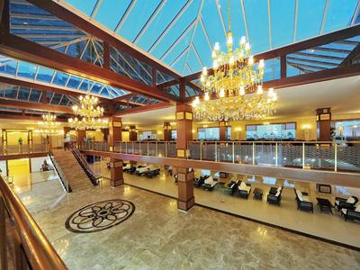 Plný amfiteátr během večerní akce s barevným osvětlením jeviště.