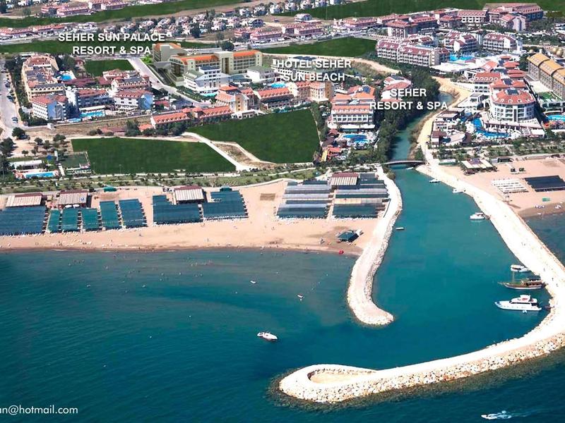 Aerial view of a hotel complex with beaches and boat docks along the coast.