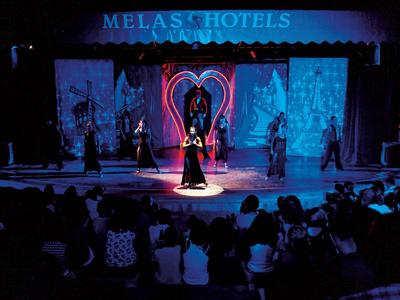 Stage performance with heart decoration and audience in a hotel