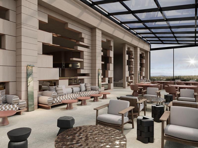 Zone de lounge d'hôtel moderne avec des fauteuils confortables et des tables élégantes sous un toit en verre.