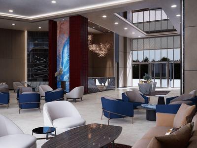 Moderne hotellobby met stijlvolle zithoeken, blauw-witte stoelen en decoratieve verlichting.