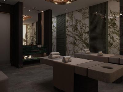 Modern spa met twee massagetafels, gedempt licht en muren met marmeren accenten.