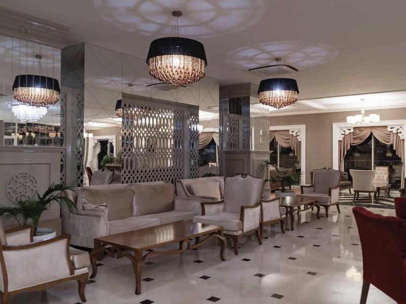 Elegant hotel lobby area with classic furniture and chandeliers.