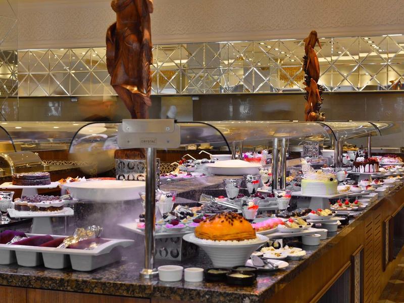 Varied buffet with cold and hot dishes in a hotel restaurant.