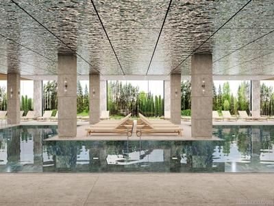 Piscina interior moderna con columnas, tumbonas y grandes ventanales con vista al jardín.