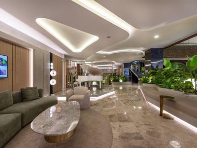 Hall d'hôtel moderne avec sièges confortables, plantes et sol en marbre élégant.