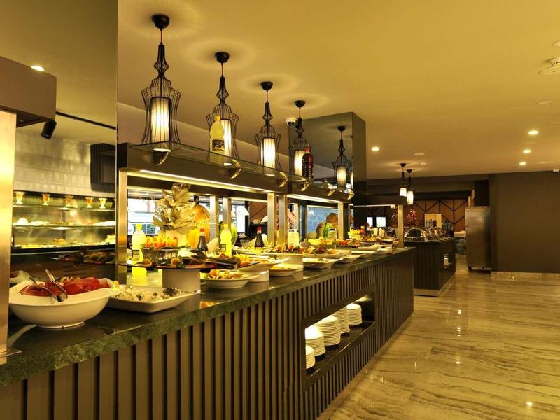 Modern buffet station with a variety of dishes in an elegant hotel restaurant.