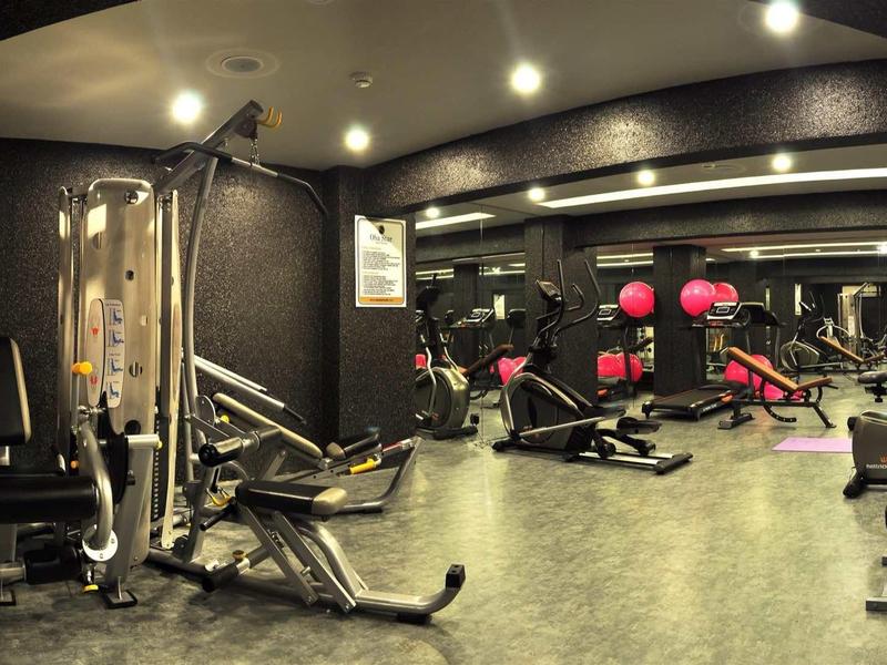 Modern gym with workout equipment and weights in a hotel