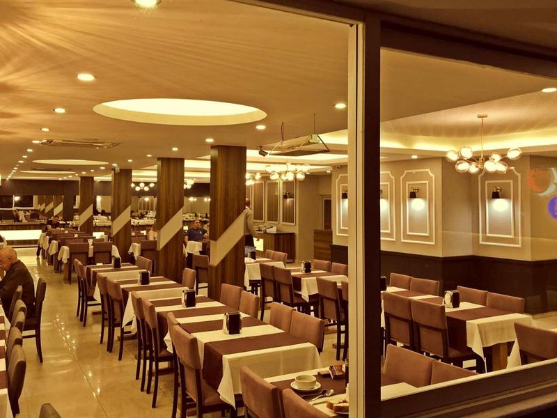 Elegant restaurant with set tables and soft lighting.