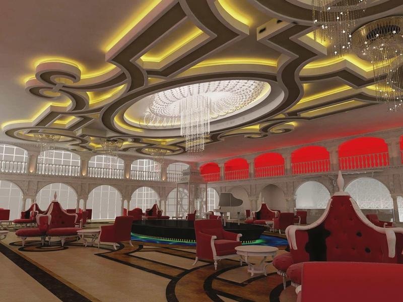 Elegant hotel lounge area with luxurious red armchairs and golden illuminated ceiling design.