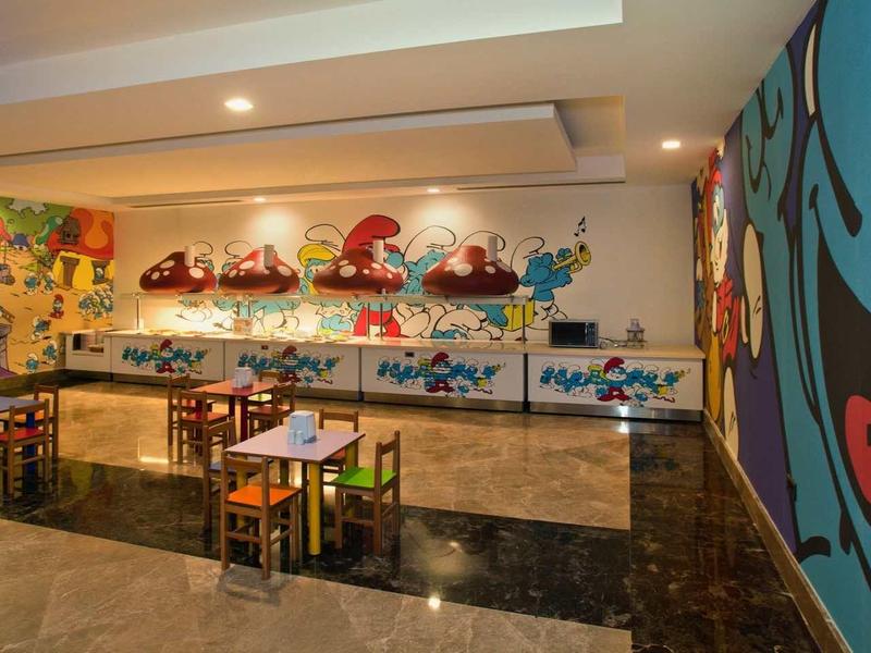 Colorful family-friendly restaurant with comic murals and child-sized furniture.