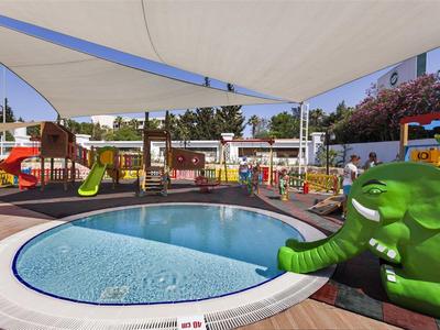 Children's pool with green elephant water toy and outdoor sunshade canopy
