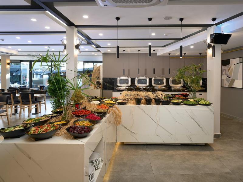 Modern buffet with fresh vegetables and salads in a bright restaurant.