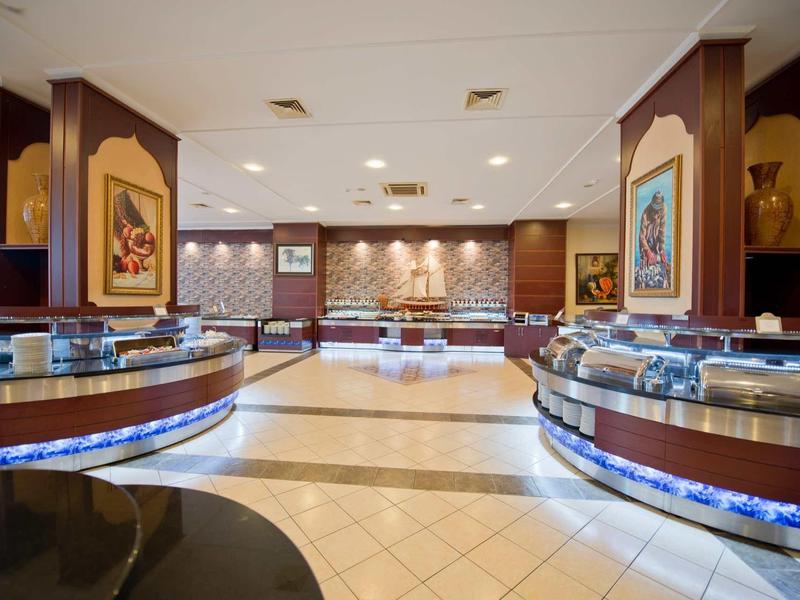 Spacious buffet area in restaurant with round counters and warm lighting.