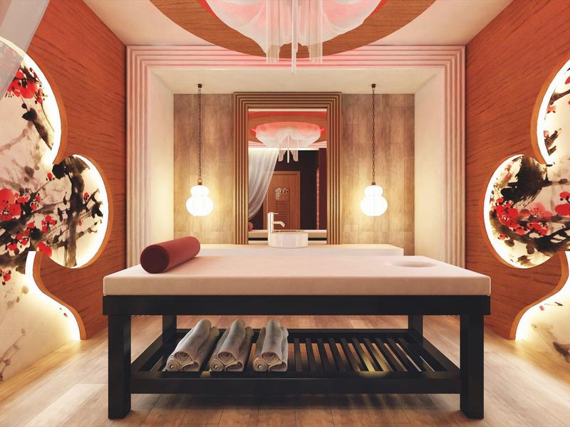 Elegancki stół do masażu w ciepło oświetlonym pokoju z dekoracyjnymi wzorami kwiatowymi na ścianach.