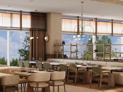 Bright hotel dining room with large windows overlooking forested mountains.