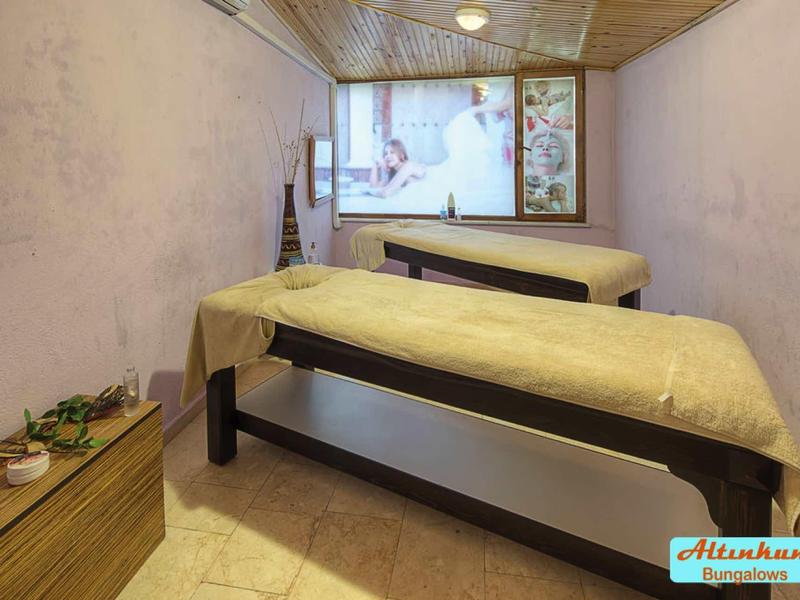 Accogliente sala benessere con due lettini da massaggio e luce soffusa.