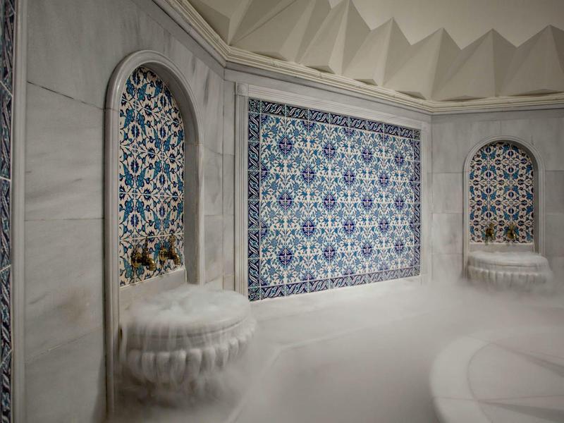 Luxurious Turkish bath area with mosaic tiles and white marble