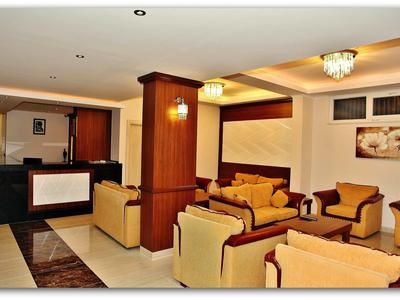 Cozy waiting area with beige armchairs and wooden elements in a hotel.