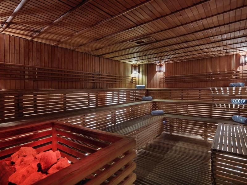 Traditional sauna with wooden benches and heated stones for relaxation.