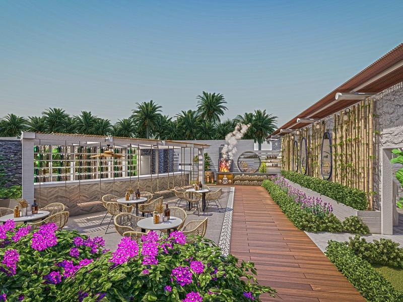 Terrasse extérieure avec tables, chaises, fleurs, palmiers et décoration naturelle, ambiance tropicale.