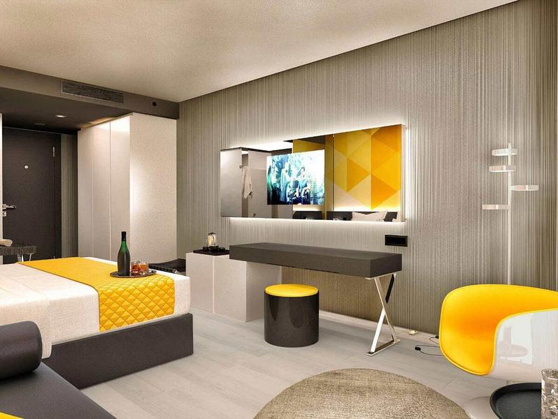Modern hotel room with yellow accents and cozy atmosphere