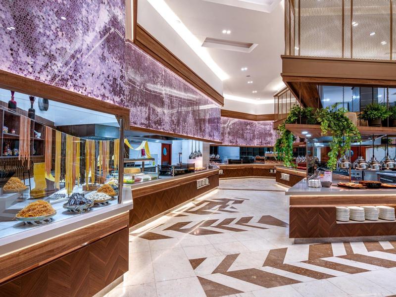 Moderne buffetruimte met marmeren muren en houten panelen in een hotel.