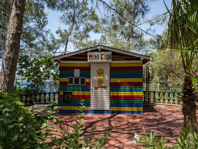 Colorful wooden pavilion in garden near the beach with trees and plants