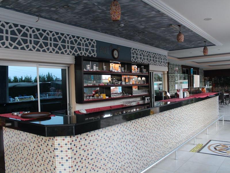 Modern hotel bar area with black countertop and decorative wall design