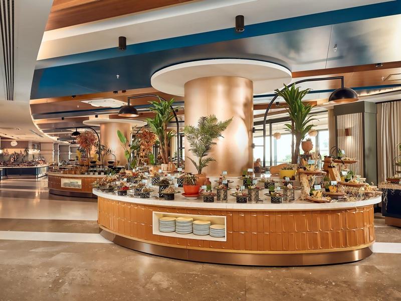 Modern hotel lobby with central floral arrangement and stylish interior.