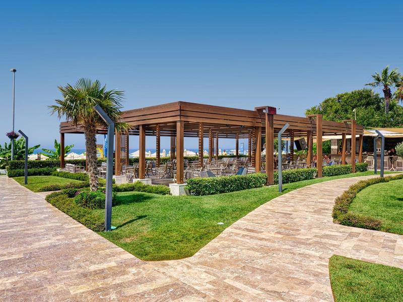 Modern terrace areas with pergola and sea view under clear sky