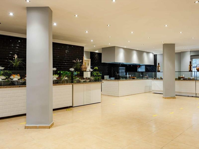 Bright, modern buffet area with counters and columns in a hotel