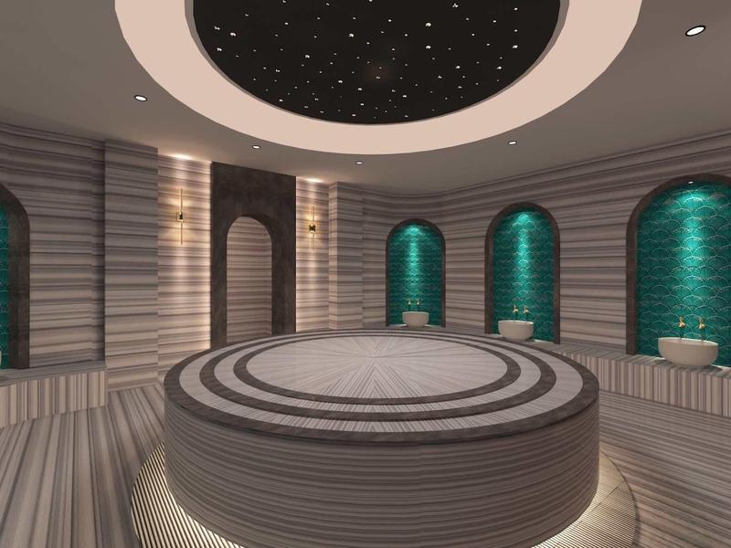 Okrągła łaźnia parowa z centralną platformą, sufitem z motywem gwiazd i podświetlanymi niszami.